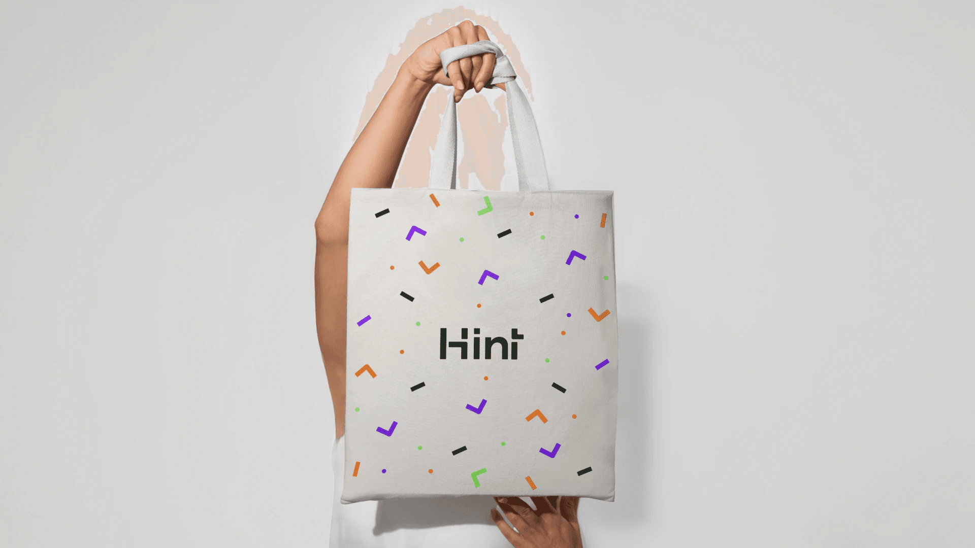 Brand exploration 2.0: a tote bag with the wordmark and scattered colored marks