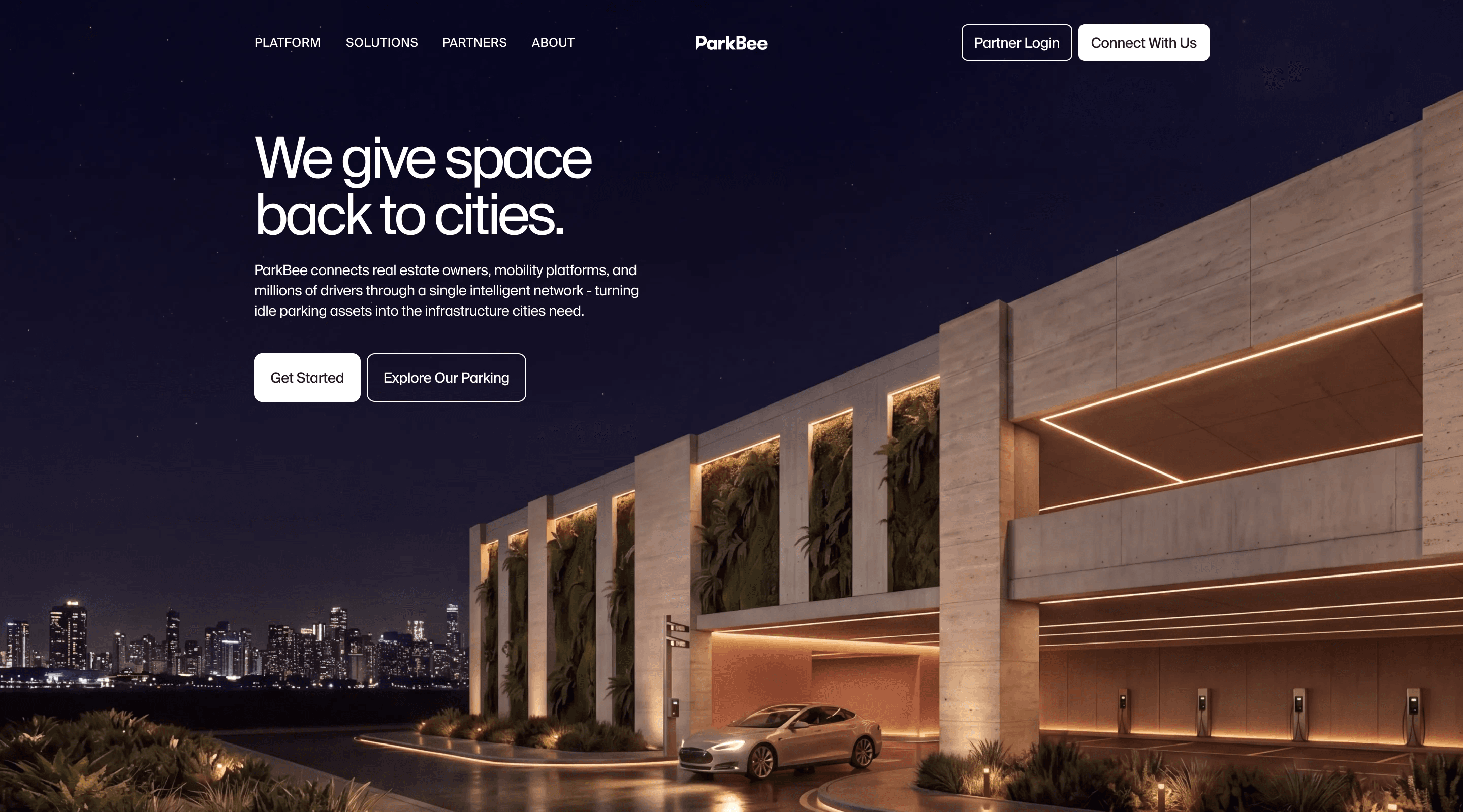 For properties page hero: We give space back to cities, over a lit building at night