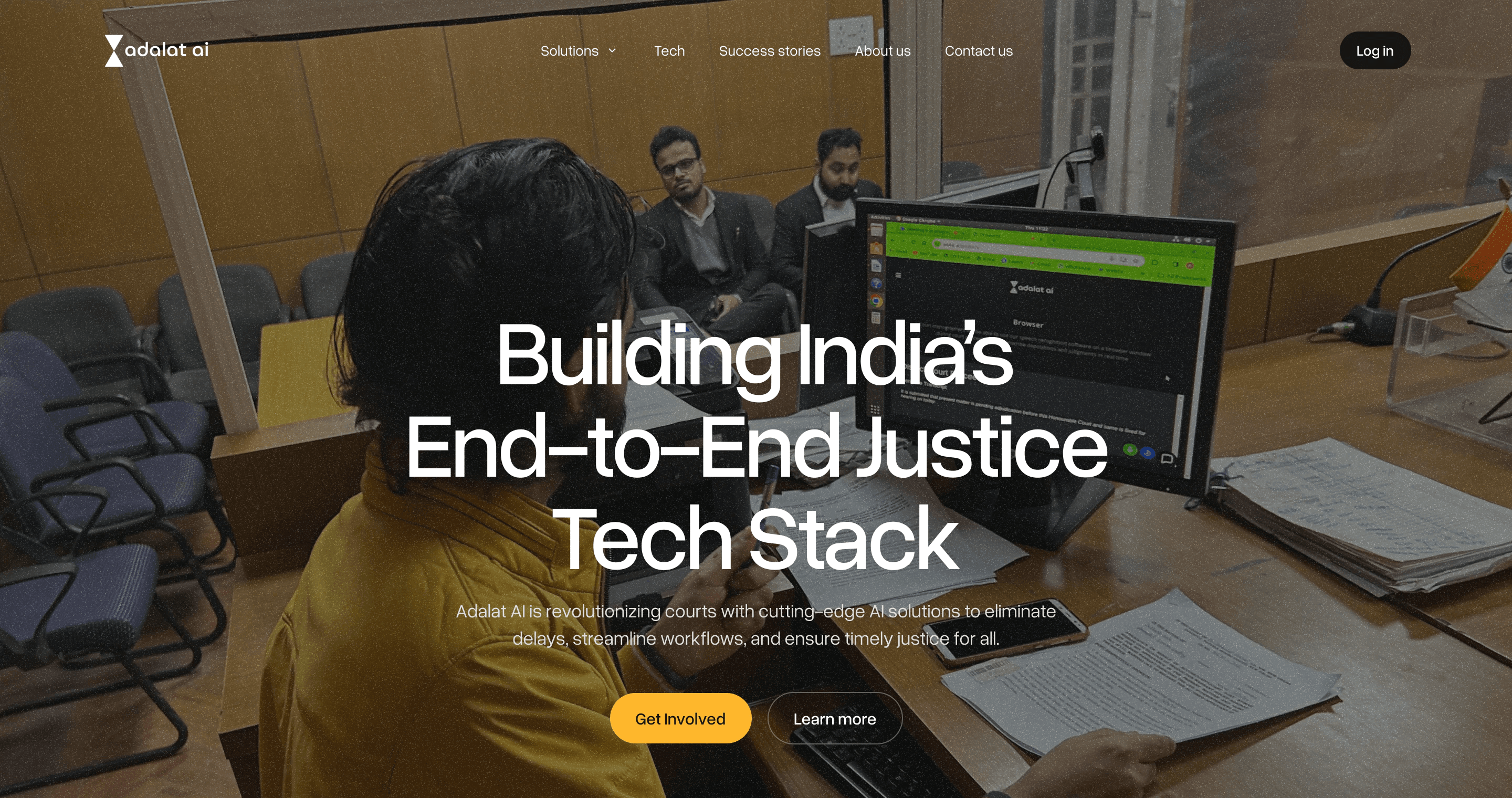 Adalat AI homepage hero: Building India’s End-to-End Justice Tech Stack, over a photo of a courtroom clerk at a computer
