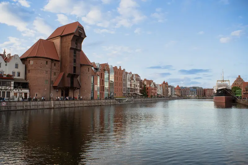 Gdańsk waterfront on the Motława, historic houses and a moored ship